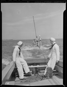 Launch towing sailboat