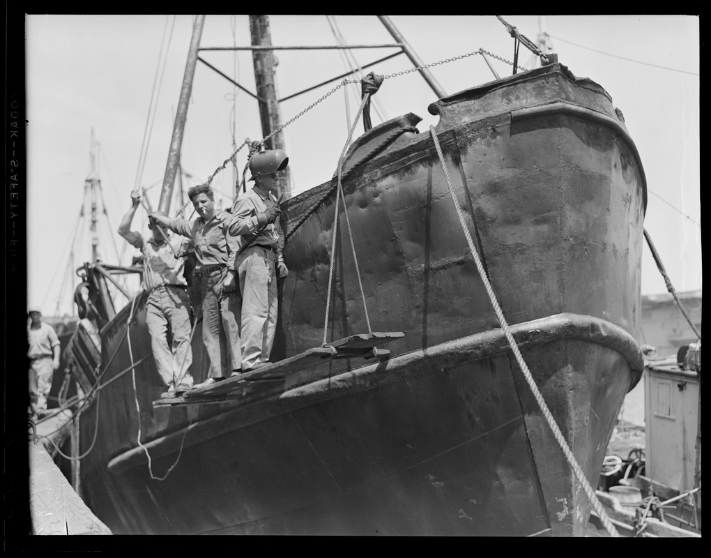 Unidentified men making boat repairs