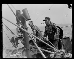 Men working aboard ship