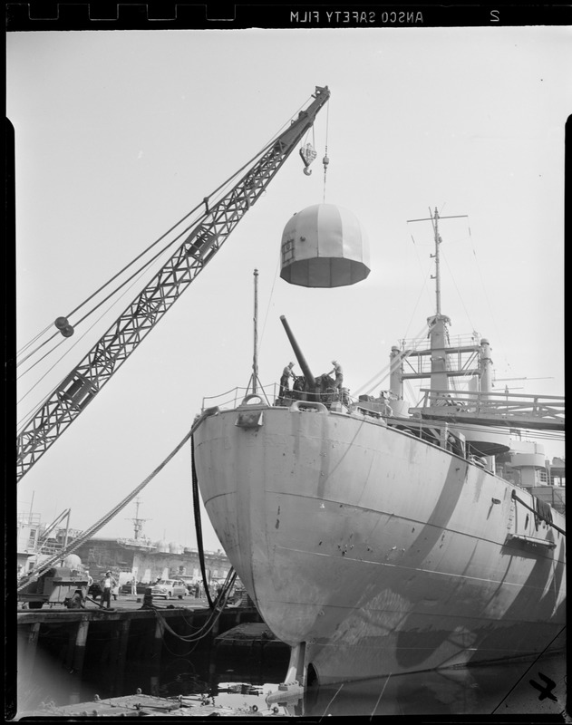 Crane lifts turret onto USS Libra