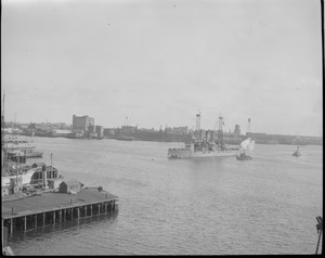 U.S. Navy ship steams into Boston Harbor - East Boston waterfront in background