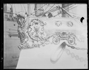 Bow of ship with ornate figurehead including woman holding eagle and eagle with stars and stripes holding arrows and olive branch