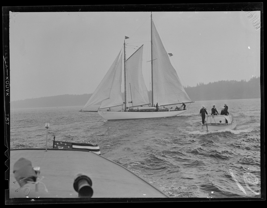 Sail boat and sailors in launch