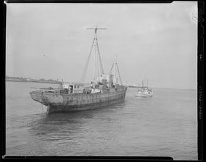 The "Vagabond Prince" tows old sailing ship out of Boston Harbor