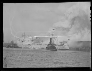Fireboat "Angus J. McDonald" alongside burning Danish freighter "Laila"