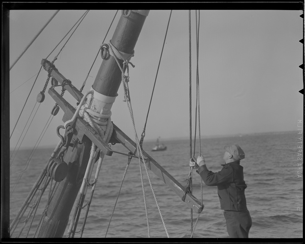 Men climb mast of sunken ship "O'Hara"