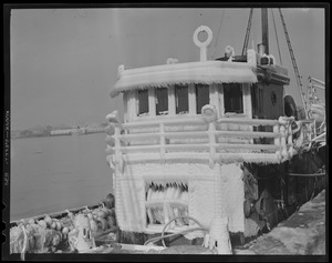 Iced up pilot house of steam trawler at fish pier