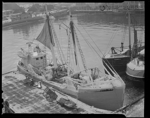 Ice covered trawler "St. Peter II" at fish pier with Sub 213 in background