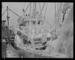 Unloading fish from ice-covered trawler "Bonnie Lou" at fish pier