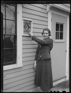 Margaret Thornton of Concord points to bullet hole in bullet hole house