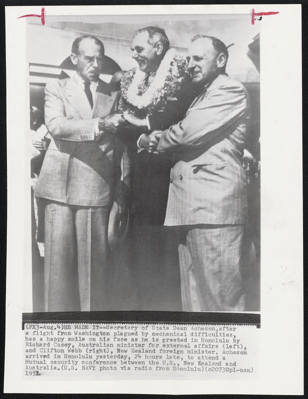 He Made It--Secretary of State Dean Acheson, after a flight from Washington plagued by mechanical difficulties, has a happy smile on his face as he is greeted in Honolulu by Richard Casey, Australian minister for external affairs (left), and Clifton Webb (right), New Zealand foreign minister. Acheson arrived in Honolulu yesterday, 24 hours late, to attend a Mutual security conference between the U.S., New Zealand and Australia.