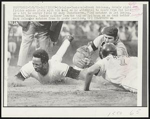 (Orioles-Yankees) - Frank Robinson, Oriole right fielder misses plate with his hand as he attempted to score from 2nd base on a hit to center field by Andy Etchebarren, Bird catcher in 1st inning. Thurman Munson, Yankee catcher lays the tag on Robinson as on deck batter Mark Belanger watches from the prone position.