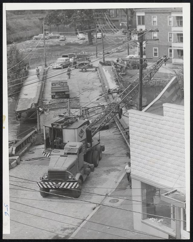 Woonsocket Readies For Rebuilding- Workers start to remove the River Street bridge in Woonsocket that was wrecked by the recent floods in this section of Rhode Island. U.S. Army Engineers are going to rebuild this and other bridges in the citty.