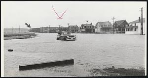 Flood Waters inundate Hull streets and maroon high school at left. The town canceled classes in all its schools today because of the number of flooded roads through which school buses could not navigate.