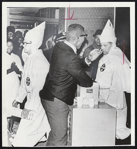 Singing Freedom songs, a Negro demonstrator picketing a segregated restaurant in Atlanta invites a Ku Klux Klansman picketing a desegregated hotel to join him as demonstrators met each other.
