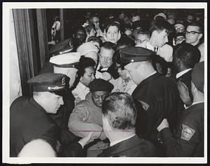 Spectator Crush at entrance to room in which School Committee met. Police are shown admitting the Rev. Vernon Carter (in beret). The clergy-man earlier this month and last had been on continuous picket duty outside building.