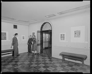 Keeper of Prints Arthur Heintzelman, center, with Paul Swenson and Muriel C. Robinson in The Wiggin Gallery, Boston Public Library