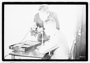 A man being shown images through an optical device