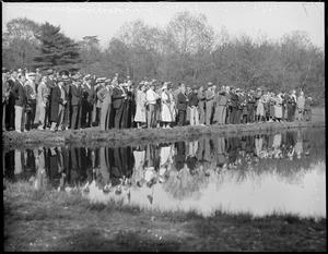 Crowd reflected in water while watching Sarazen and Ouimet duel at Weston Country Club