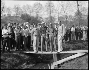 Four golfers pose on bridge