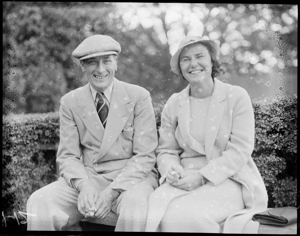 Man and woman pose for photographer during golf championships at Brookline Country Club