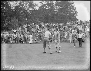 Golfers shake hands on the green, during championship at Brookline Country Club