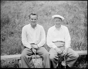 Two golfers pose for camera
