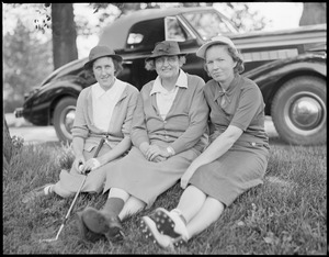 Two women golfers pose with older woman