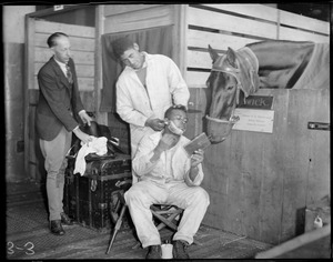 Behind the curtain at the Boston Horse Show, Boston Garden, a groom gets a shave and a haircut