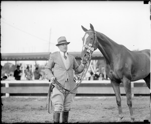 Danny Shea holding Hugh Bancroft, Jr.'s Pastime at Brockton Fair. Horse is prize jumper.