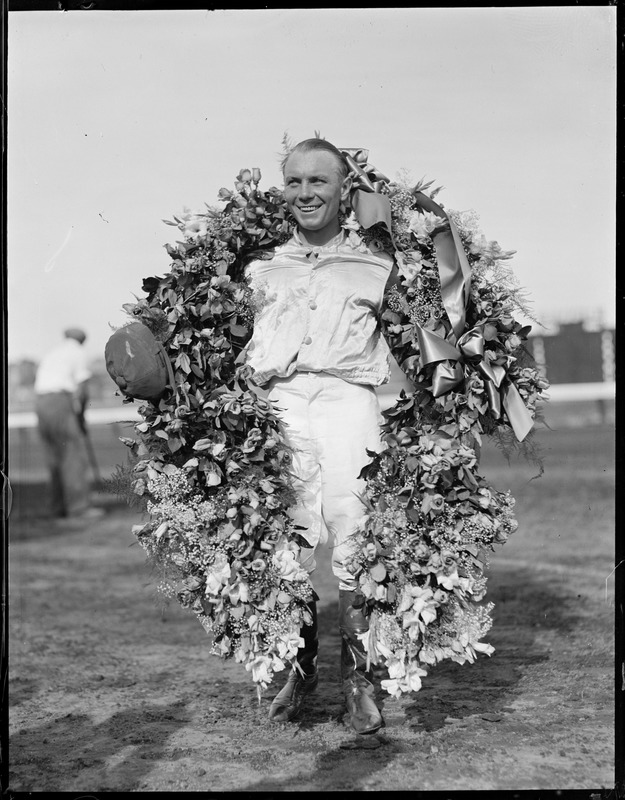 Jockey R. Workman on Time Supply's wreath after winning the fifth race at Suffolk downs