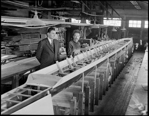 Eight oar scull being built at Harvard. Coach Charles Whiteside (l) builder Bill Lutz (r) - 30 years of building sculls, now 72 years old.