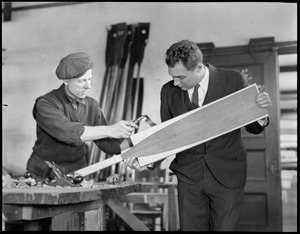 L-R: Bruce Flett - oar maker for Harvard shows eastern spruce oar to coach Charlie Whiteside. Eastern spruce is used for a flatter oar.