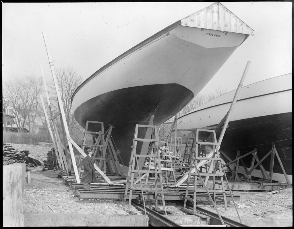 W. Sterling Burgess, boat designer of fame, looking over 1929 cup defender Resolute at Bristol, R.I.
