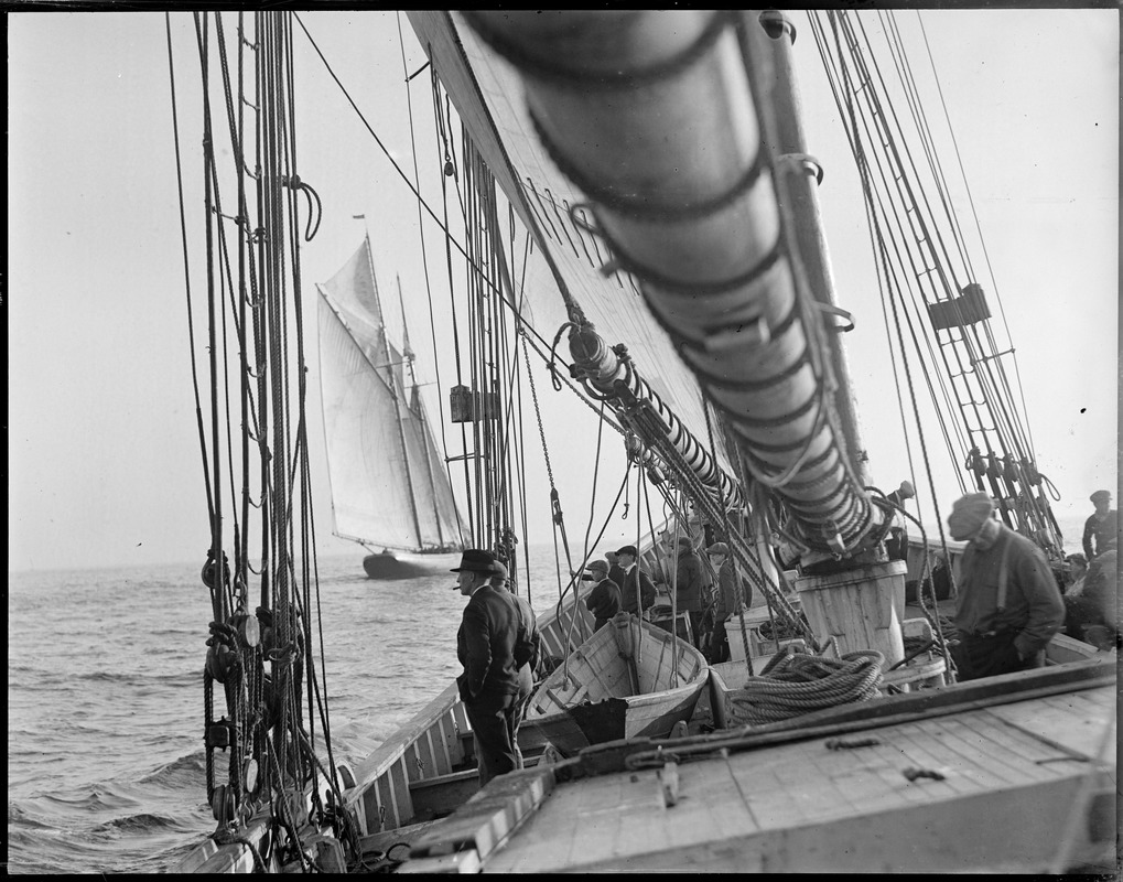 Glimpse of the fishing schooner Columbia through rigging of the Elizabeth Howard.
