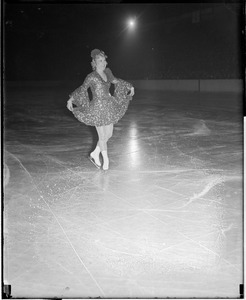 Sonja Henie curtsies on the ice