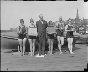 Women holding prizes at swimming competition