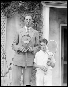 G. Lyttleton Rogers, Irish Davis Cup star, holds old racquet and Johnny Palfrey holds new, at Longwood