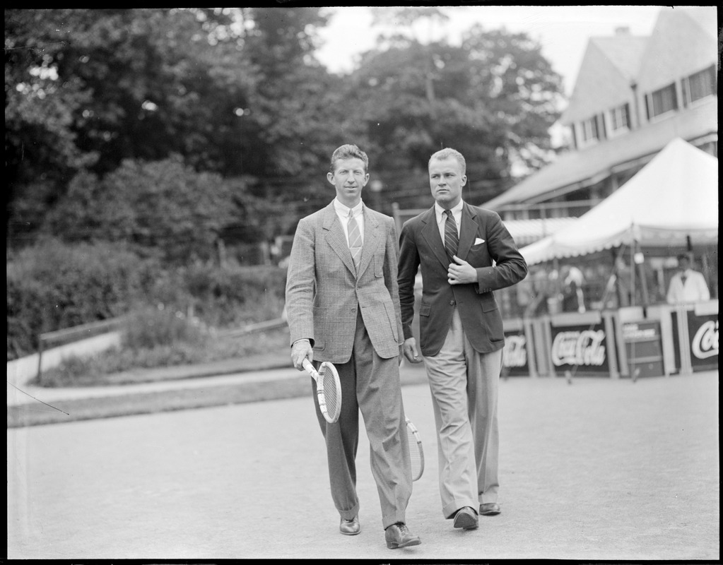 Two players in suits with racquets