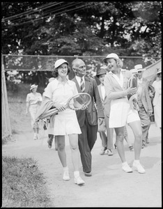 Man walks with two women players