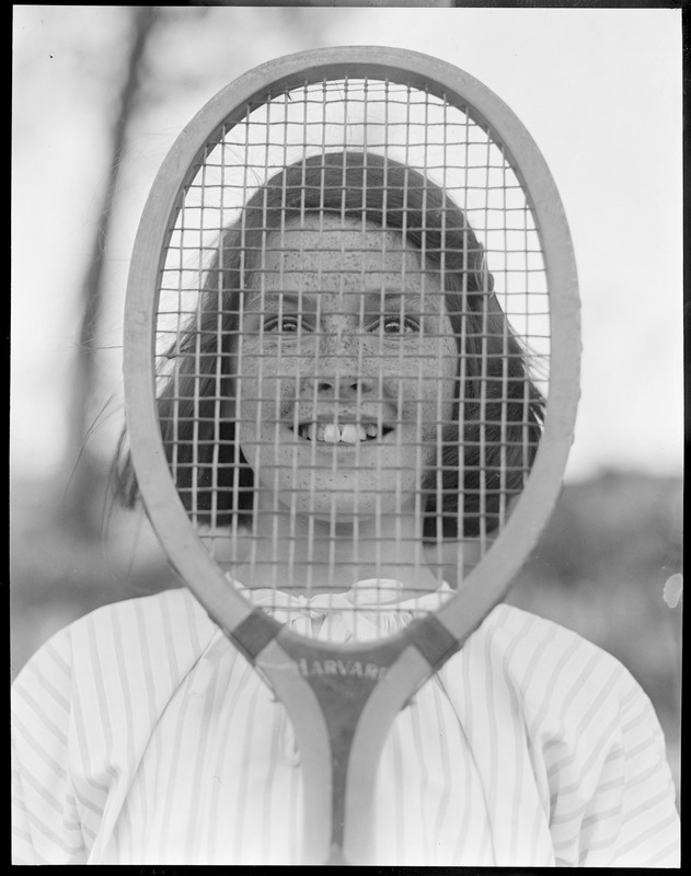 Sarah Palfrey, tennis star, hides behind her racquet