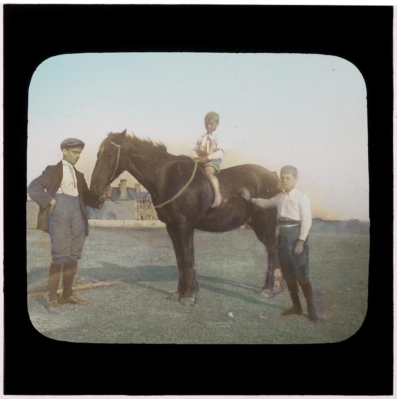 Child on a horse with two handlers - Digital Commonwealth