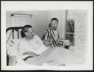 Pioneer Flier Bert Acosta In Sanitorium Here - The flier who piloted Adm. Richard Byrd across the Atlantic in 1927 gets a cigarette from roommate and old time friend Tommy Flanagan. Acosta Expressed surprise that someone was using his name while bargaining with the late Lew Wentz, one time oilman from Ponca city, Okla., Seeking financial backing for an endurance flight. He was discovered at the sanitorium the other day. He told reporters he hadn't been west in the last five years.