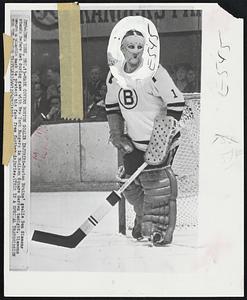 Mask Covers Boston Goalie Injuries - Boston Bruins' goalie Don Simmons stands before net during game with New York Rangers in Madison Square Garden tonight. Simmons wears a plastic mask to protect his face from further injuries.