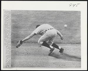 Tip-Toe Try--Dick McAuliffe, Detroit shortstop, stands on his tip-toes and kicks up dust as he makes a vain try for a drive by Minnesota Twins' Harmon Killebrew in first inning of first game of American League doubleheader today in Twin Cities. The drive scored two runs.