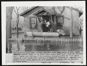 Pierre Residents Leave Homes Behind as Flood Waters Threaten:- Raymond Hinsey of the Pierre Water Rescue Squad (left) helps Leo Schiebel into a rescue boat with some of his household belongings. With the flood waters rising at a rate beyond which U.S. Corps of Engineers predicted, all residents were checked by the rescue squads. The Fire Department equipment also was evacuated to higher ground.