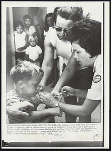 Gulfport, Miss. -- A Hurt For The Good -- The typhoid shot five year old Harold Oliver is getting from a public health nurse in Gulfport today may hurt a little, but he and other survivors of Hurricane Camille are getting them for their own protection. Behind him some of his little friends wait their turn for the needle. Weather.