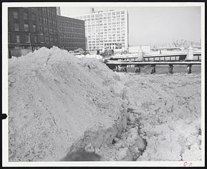 Tons Of Snow fill Ft. Point Channel, near South Station. This is one of the major points for dumping by Boston snow removal crews. City is still digging out after the big Sunday storm of 19.4 inches.