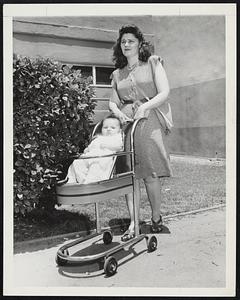 A combination stroller and high chair invented by C. B. Johnson. It is here being demonstrated at the World Inventors Exposition by 3-month-old Barbara Sue Johnson and her mother, Mrs. Margaret Johnson.