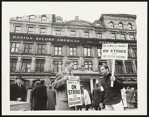 Boston Newspaper Strike...Edward T. O'Neil of Dorchester, Boston Typographical Union #13,(L), and Richard Manzi of Stoneham, Boston Mailers Union #1, are shown as they arrived at the Boston Record American- Sunday Advertiser Building to take up position in picket lines after union printers and mailers voted overwhelmingly 3/6 to go on strike against Boston's five daily newspapers.